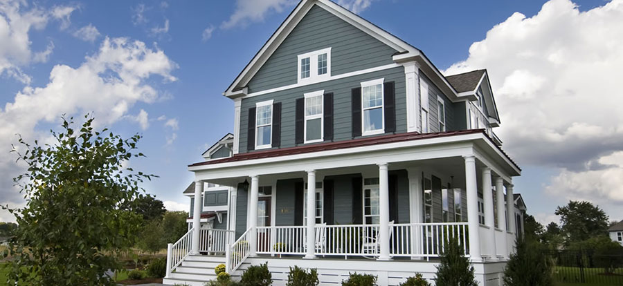 Black louvered shutters on a gray country house